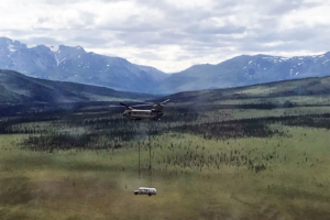 An Alaska National Guard helicopter airlifts the “Into the Wild” bus from the Stampede Trail. Photo courtesy Alaska National Guard.